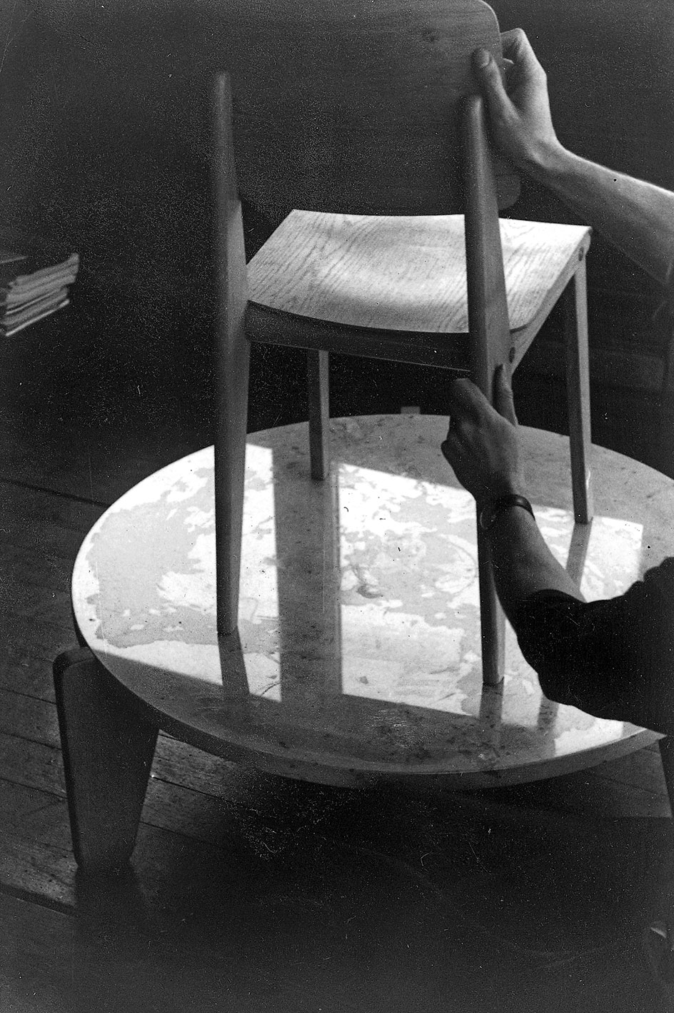 Chaise bois démontable CB 22. Démonstration du montage par André Le Stang, collaborateur des Ateliers Jean Prouvé, dans le bureau de Jean Prouvé à Maxéville, c. 1949.