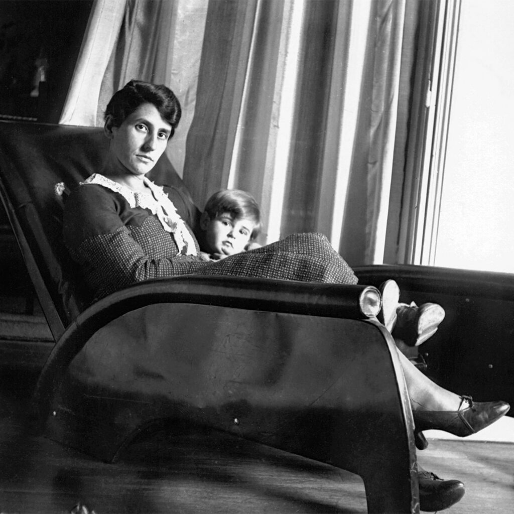 Madeleine Prouvé and her daughter Françoise, in a prototype of the Grand Repos armchair in Nancy, ca. 1930.