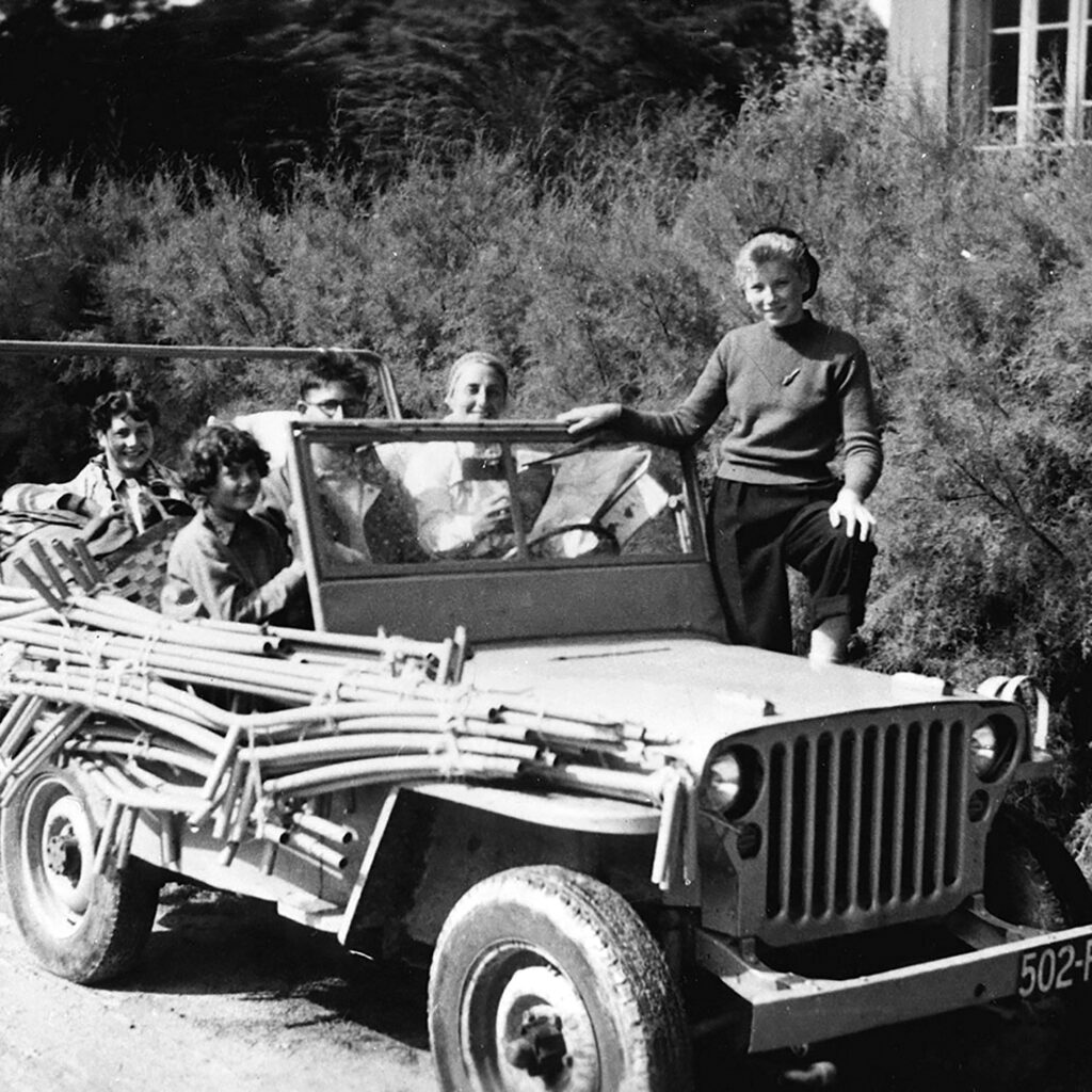 The Prouvé family on holiday with the frame of the “Papillon” (Butterfly) tent strapped to a jeep, ca. 1950.