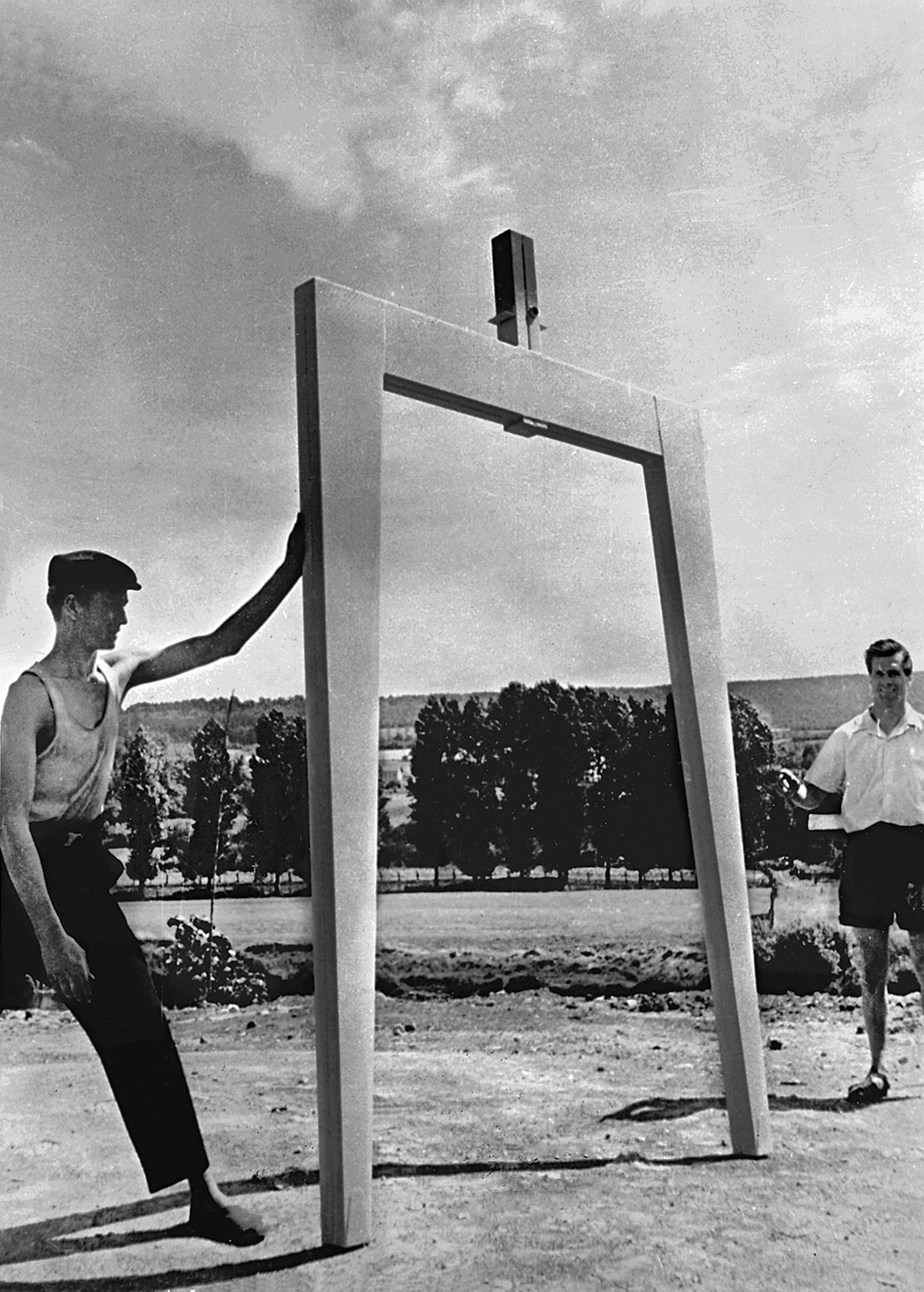 Pierre Prouvé and a worker displaying a Metropole house portal frame, Maxéville, ca. 1950.