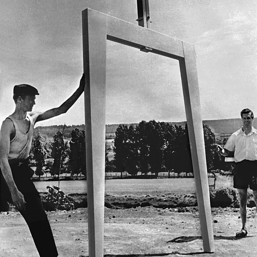 Pierre Prouvé and a worker displaying a Metropole house portal frame, Maxéville, ca. 1950.