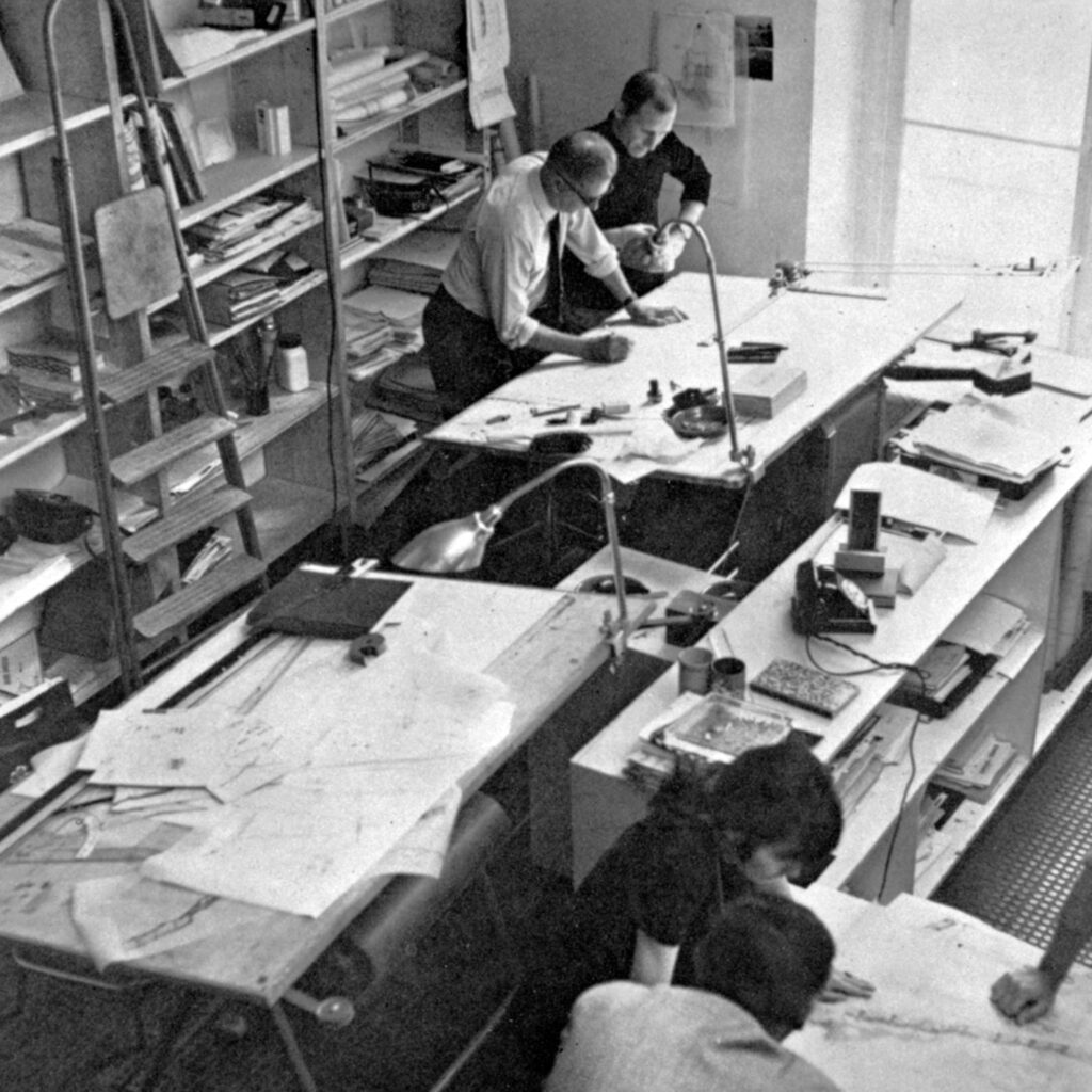 Jean Prouvé et ses collaborateurs, Jacques Bédier, Reiko Hayama et Serge Binotto dans son atelier d’architecture, rue des Blancs-Manteaux, Paris, c. 1970.