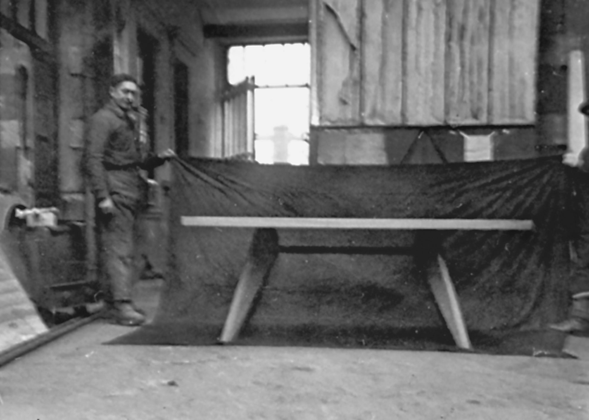 S.A.M. table, 1941. Prototype with wood legs and metal crossmember fixed with stirrups. View in the workshop, ca. 1945.