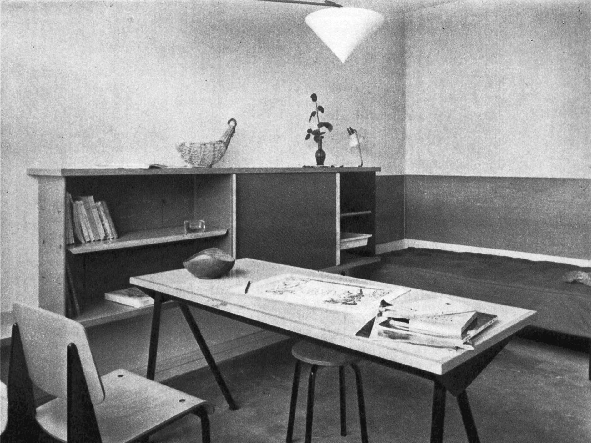 Cité Universitaire, Antony (architects E. Beaudouin and P. Fournier, 1951–1957). One of the 150 single rooms furnished by the Prouvé-Perriand-Villiger team, 1955: type Antony bookcase (adaptation of the Mexique bookcase by Charlotte Perriand), Compas desk with tube legs, Métropole no. 305 chair, fauteuil léger no. 356, SCAL no. 450 bed (with a swiveling tablet by Charlotte Perriand).