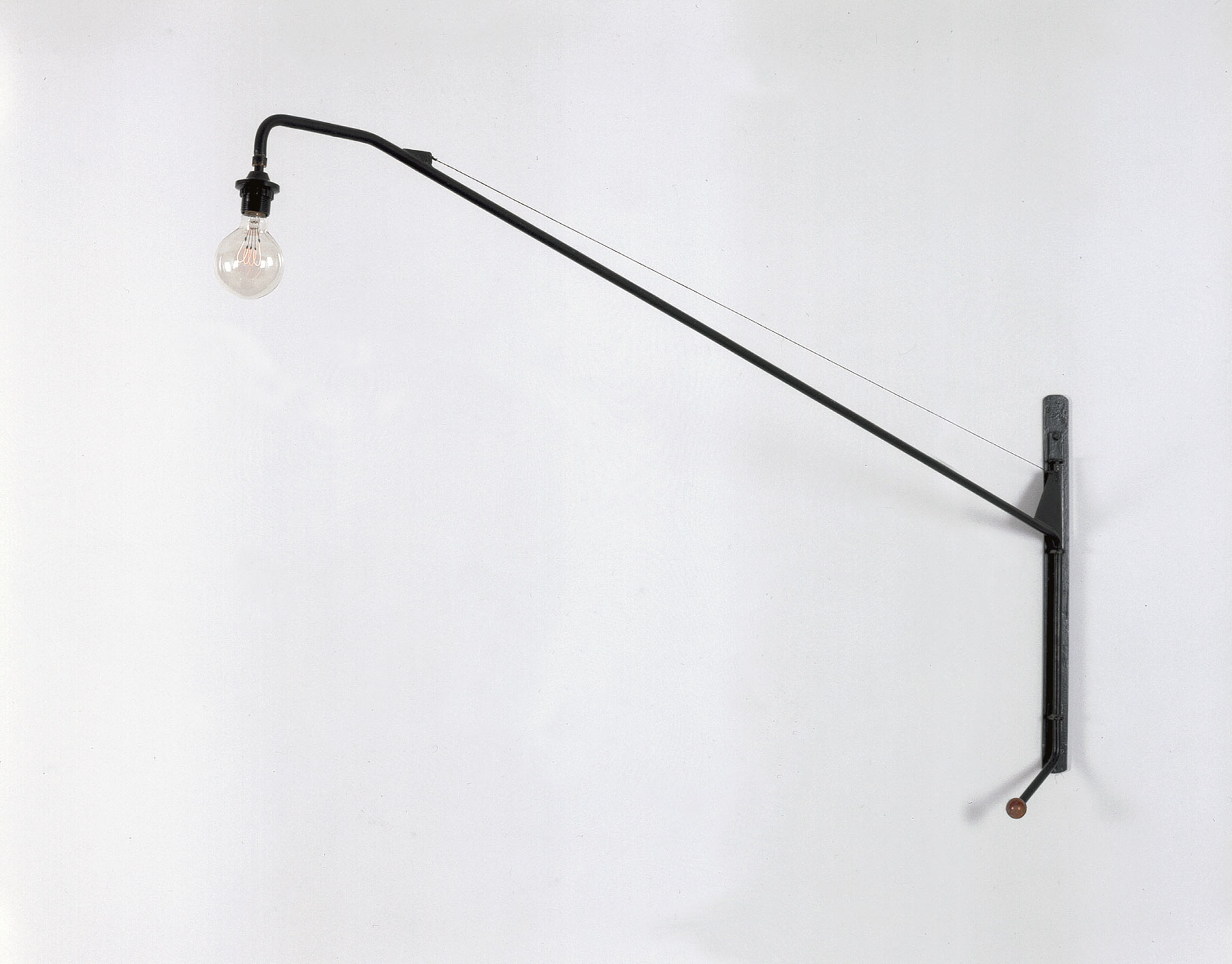 Swing-jib lamp no. 602, with handle for orientation and adjustment, variant with an oblique curved arm, for Air France building, Brazzaville, 1952.
